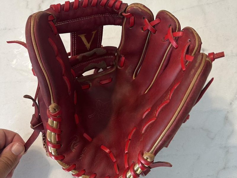 A red Rawlings baseball glove fully relaced with red leather lace by Hideworks Glove Co. in Oakville, Ontario